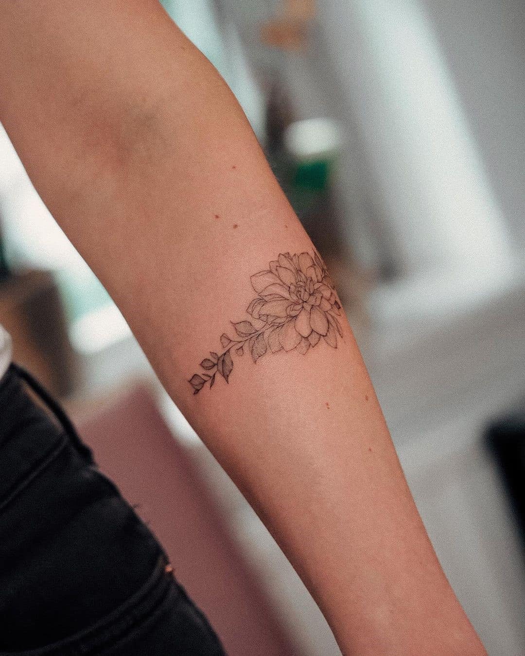 Hand poked lotus flower bracelet tattoo.